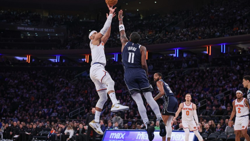 New York Knicks guard Josh Hart (3) shoots as Dallas Mavericks guard Kyrie Irving (11) defends during the second half at Madison Square Garden