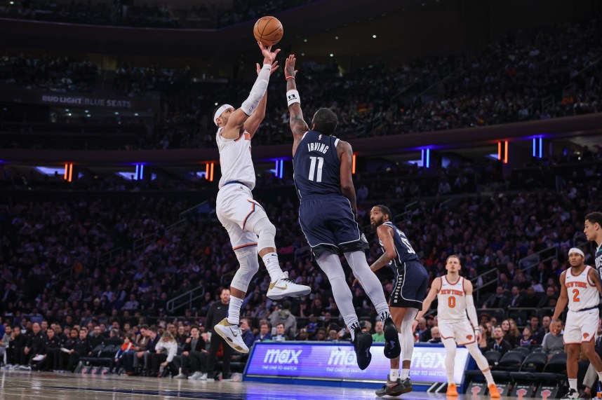 New York Knicks guard Josh Hart (3) shoots as Dallas Mavericks guard Kyrie Irving (11) defends during the second half at Madison Square Garden
