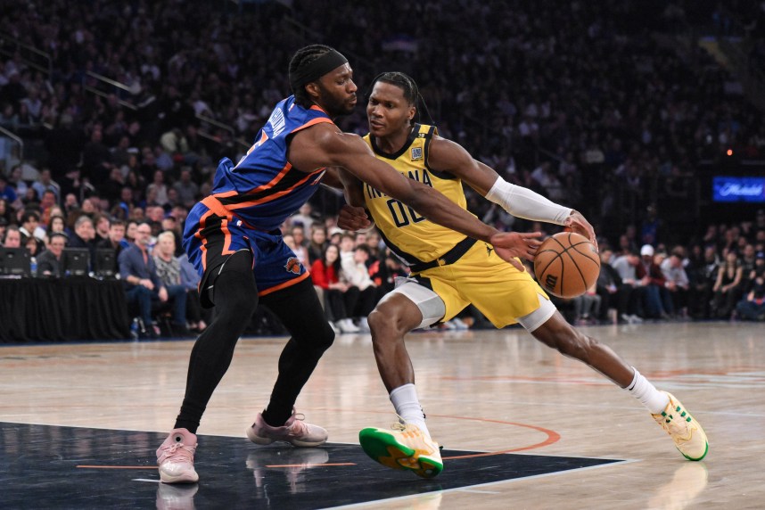 Indiana Pacers guard Bennedict Mathurin (00) drives to the basket while being defended by New York Knicks forward Precious Achiuwa (5) during the first quarter at Madison Square Garden