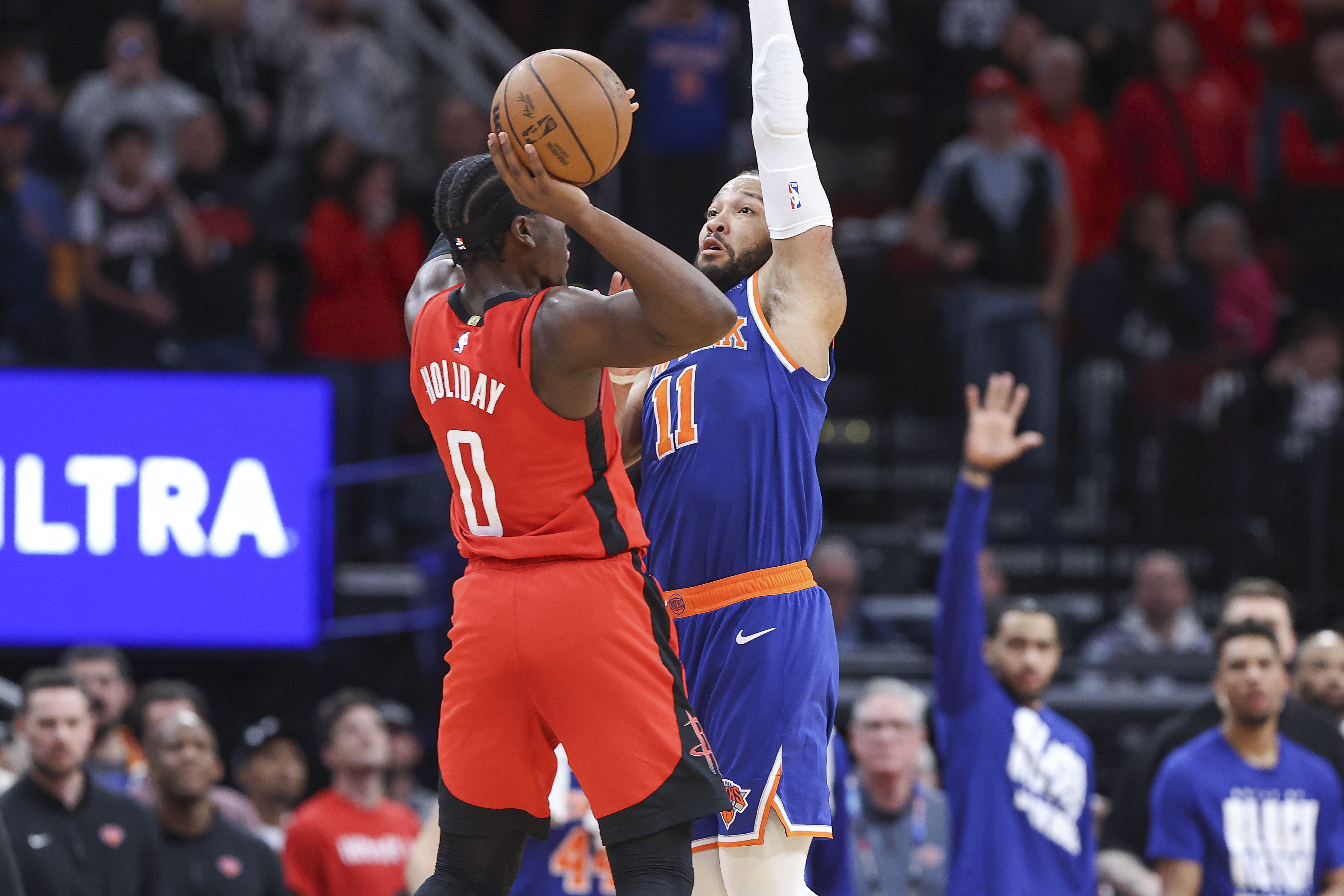 New York Knicks guard Jalen Brunson (11) fouls Houston Rockets guard Aaron Holiday (0) on a play in the final moments of the fourth quarter at Toyota Center