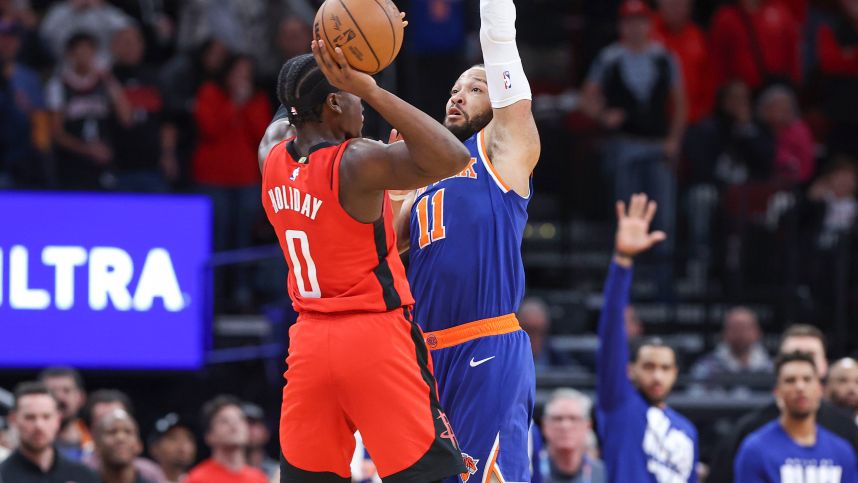 New York Knicks guard Jalen Brunson (11) fouls Houston Rockets guard Aaron Holiday (0) on a play in the final moments of the fourth quarter at Toyota Center