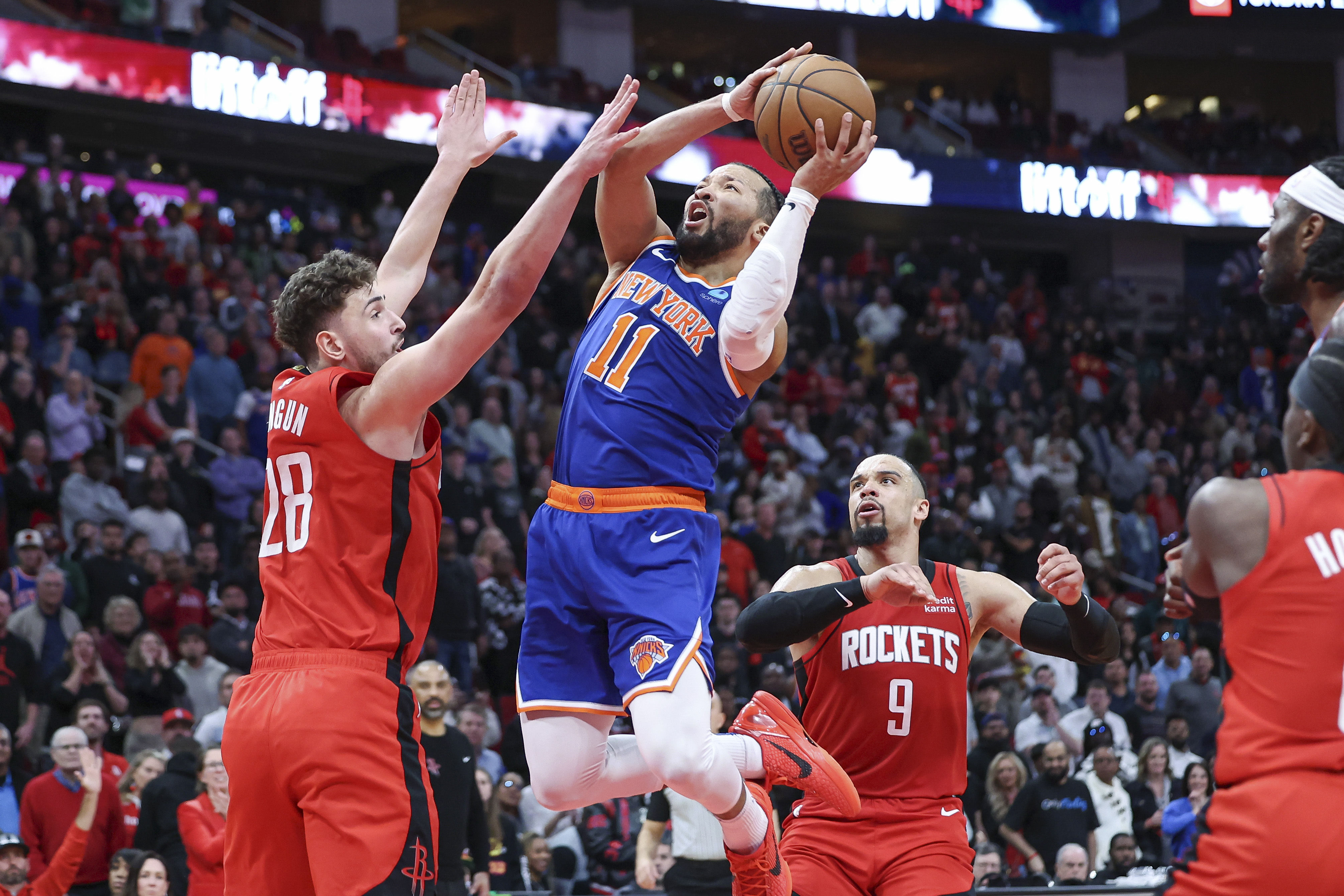 New York Knicks guard Jalen Brunson (11) attempts to score as Houston Rockets center Alperen Sengun (28) defends during the fourth quarter at Toyota Center