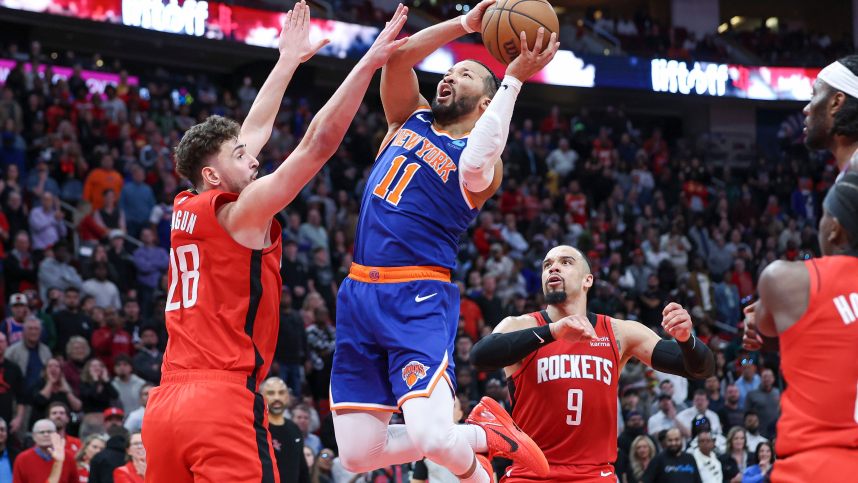 New York Knicks guard Jalen Brunson (11) attempts to score as Houston Rockets center Alperen Sengun (28) defends during the fourth quarter at Toyota Center