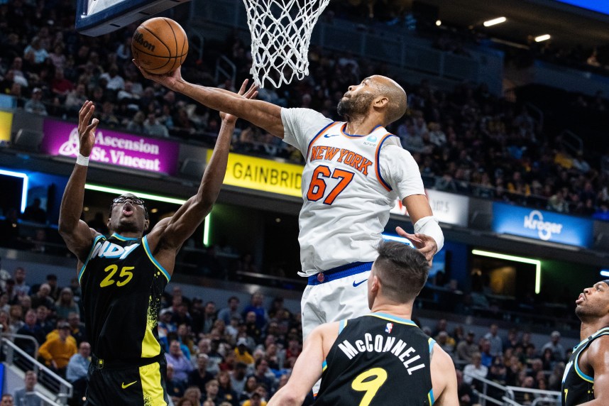 New York Knicks forward Taj Gibson (67) rebounds the ball while Indiana Pacers forward Jalen Smith (25) defends in the second half at Gainbridge Fieldhouse