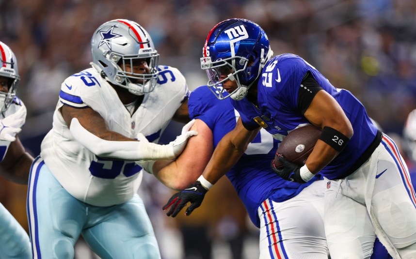 New York Giants running back Saquon Barkley (26) runs with the ball as Dallas Cowboys defensive tackle Johnathan Hankins (95) defends during the first quarter at AT&T Stadium