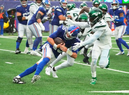New York Jets safety Jordan Whitehead (3) tackles New York Giants quarterback Tommy DeVito (15) in the fourth quarter at MetLife Stadium