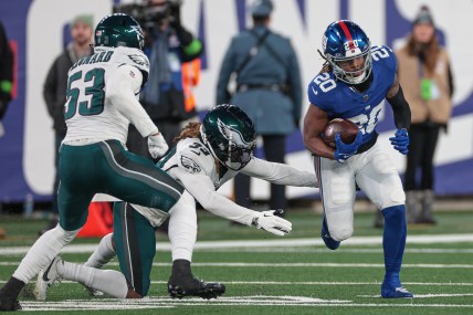 New York Giants running back Eric Gray (20) carries the ball as Philadelphia Eagles cornerback Bradley Roby (33) and linebacker Shaquille Leonard (53) pursue during the second half at MetLife Stadium