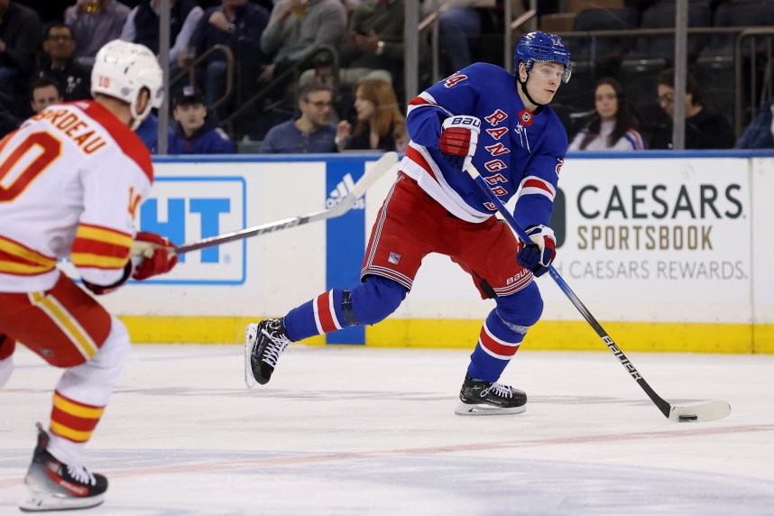 New York Rangers right wing Kaapo Kakko (24) skates with the puck against Calgary Flames center Jonathan Huberdeau (10) during the third period at Madison Square Garden