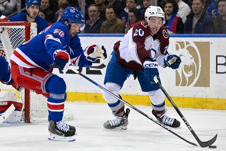 New York Rangers defenseman Erik Gustafsson (56) and Colorado Avalanche center Ross Colton (20) battle over the puck during the second period at Madison Square Garden