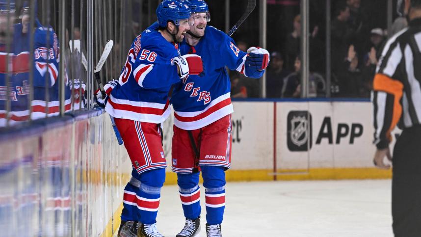 New York Rangers left wing Alexis Lafreniere (13) celebrates his game winning goal during the overtime period against the Colorado Avalanche with New York Rangers defenseman Erik Gustafsson (56) at Madison Square Garden
