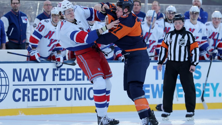 New York Rangers center Matt Rempe (73) and New York Islanders left wing Matt Martin (17) fight during the first period of a Stadium Series ice hockey game at MetLife Stadium
