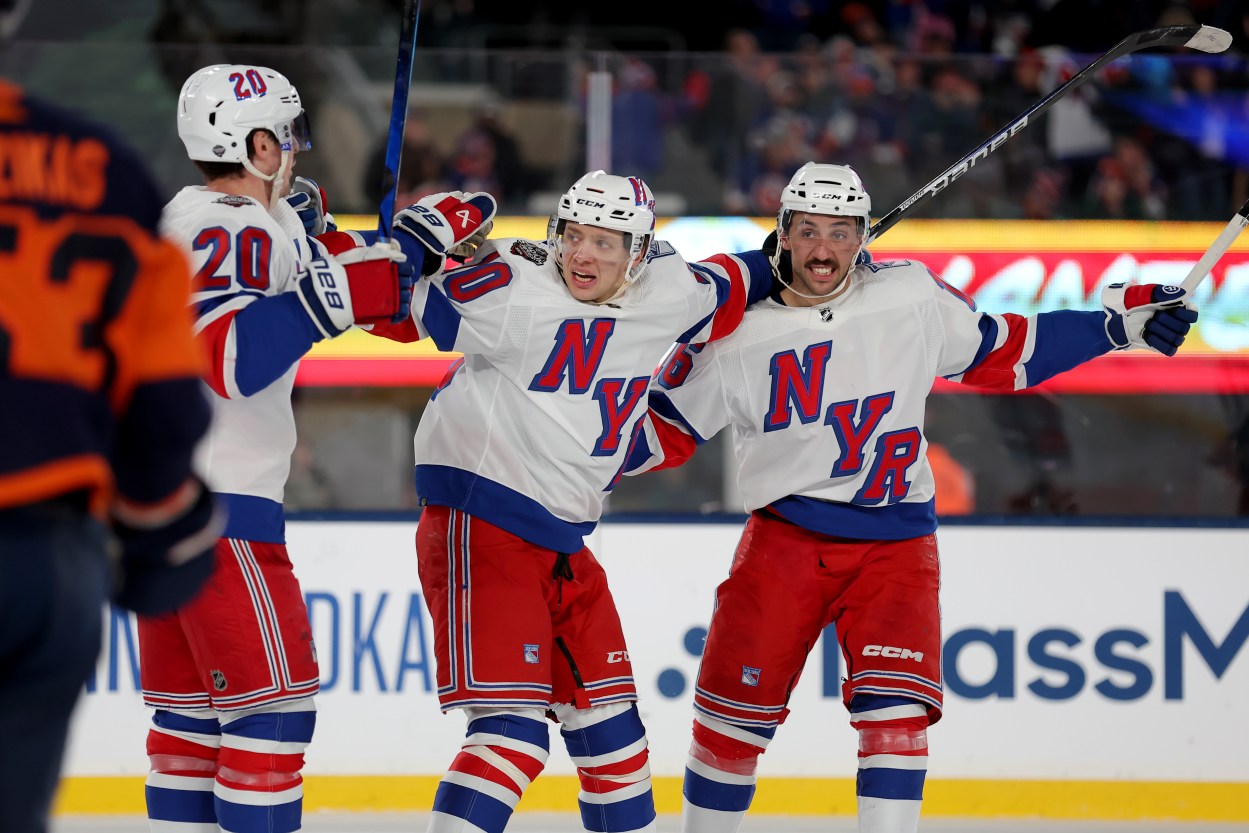 New York Rangers left wing Chris Kreider (20) celebrates his goal against the New York Islanders with left wing Artemi Panarin (10) and center Vincent Trocheck (16) during the third period of a Stadium Series ice hockey game at MetLife Stadium