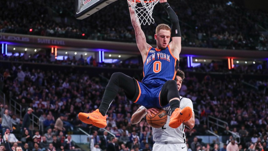 New York Knicks guard Donte DiVincenzo (0) dunks in front of Brooklyn Nets forward Cameron Johnson (2) in the fourth quarter at Madison Square Garden