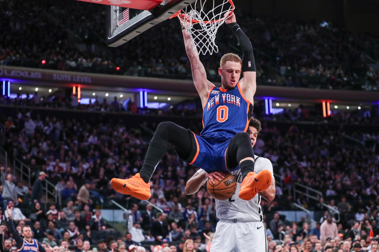 New York Knicks guard Donte DiVincenzo (0) dunks in front of Brooklyn Nets forward Cameron Johnson (2) in the fourth quarter at Madison Square Garden