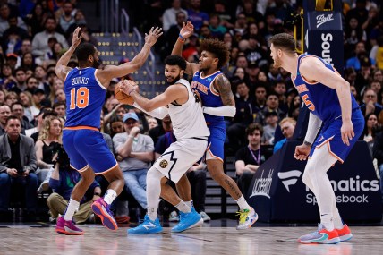 Denver Nuggets guard Jamal Murray (27) controls the ball under pressure from New York Knicks guard Alec Burks (18) and guard Miles McBride (2) as center Isaiah Hartenstein (55) defends in the fourth quarter at Ball Arena