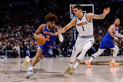 New York Knicks guard Miles McBride (2) drives to the basket against Denver Nuggets forward Michael Porter Jr. (1) in the fourth quarter at Ball Arena