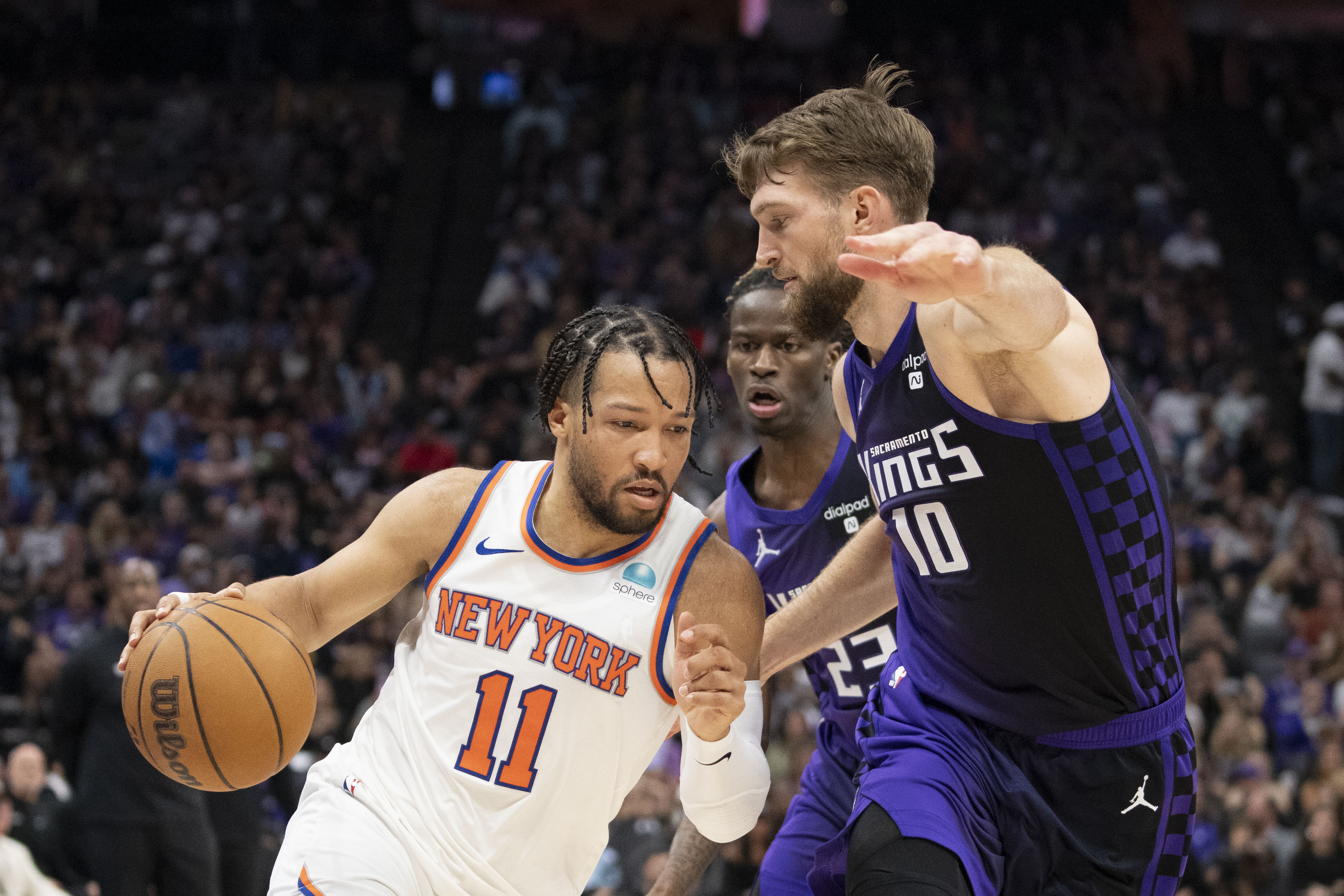 New York Knicks guard Jalen Brunson (11) dribbles the basketball against Sacramento Kings forward Domantas Sabonis (10) during the second quarter at Golden 1 Center