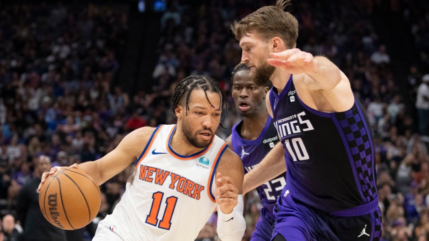 New York Knicks guard Jalen Brunson (11) dribbles the basketball against Sacramento Kings forward Domantas Sabonis (10) during the second quarter at Golden 1 Center