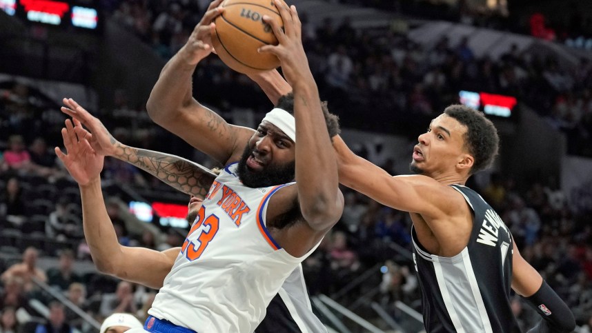 New York Knicks center Mitchell Robinson (23) takes rebound away from San Antonio Spurs forward Victor Wembanyama (1) during the first half at Frost Bank Center