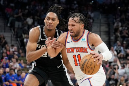 New York Knicks guard Jalen Brunson (11) drives to the basket while defended by San Antonio Spurs guard Devin Vassell (24) during overtime at Frost Bank Center