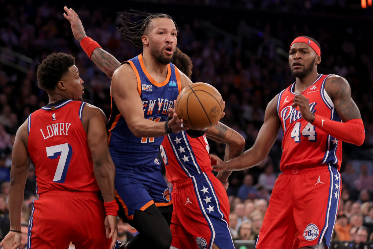 New York Knicks guard Jalen Brunson (11) looks to pass the ball against Philadelphia 76ers guards Kyle Lowry (7) and Kelly Oubre Jr. (9) and forward Paul Reed (44) during the third quarter at Madison Square Garden