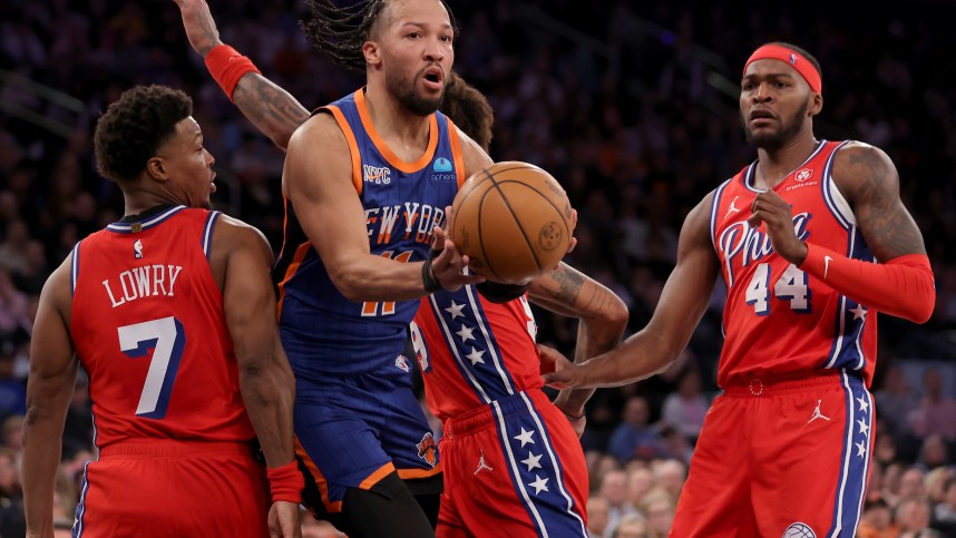New York Knicks guard Jalen Brunson (11) looks to pass the ball against Philadelphia 76ers guards Kyle Lowry (7) and Kelly Oubre Jr. (9) and forward Paul Reed (44) during the third quarter at Madison Square Garden