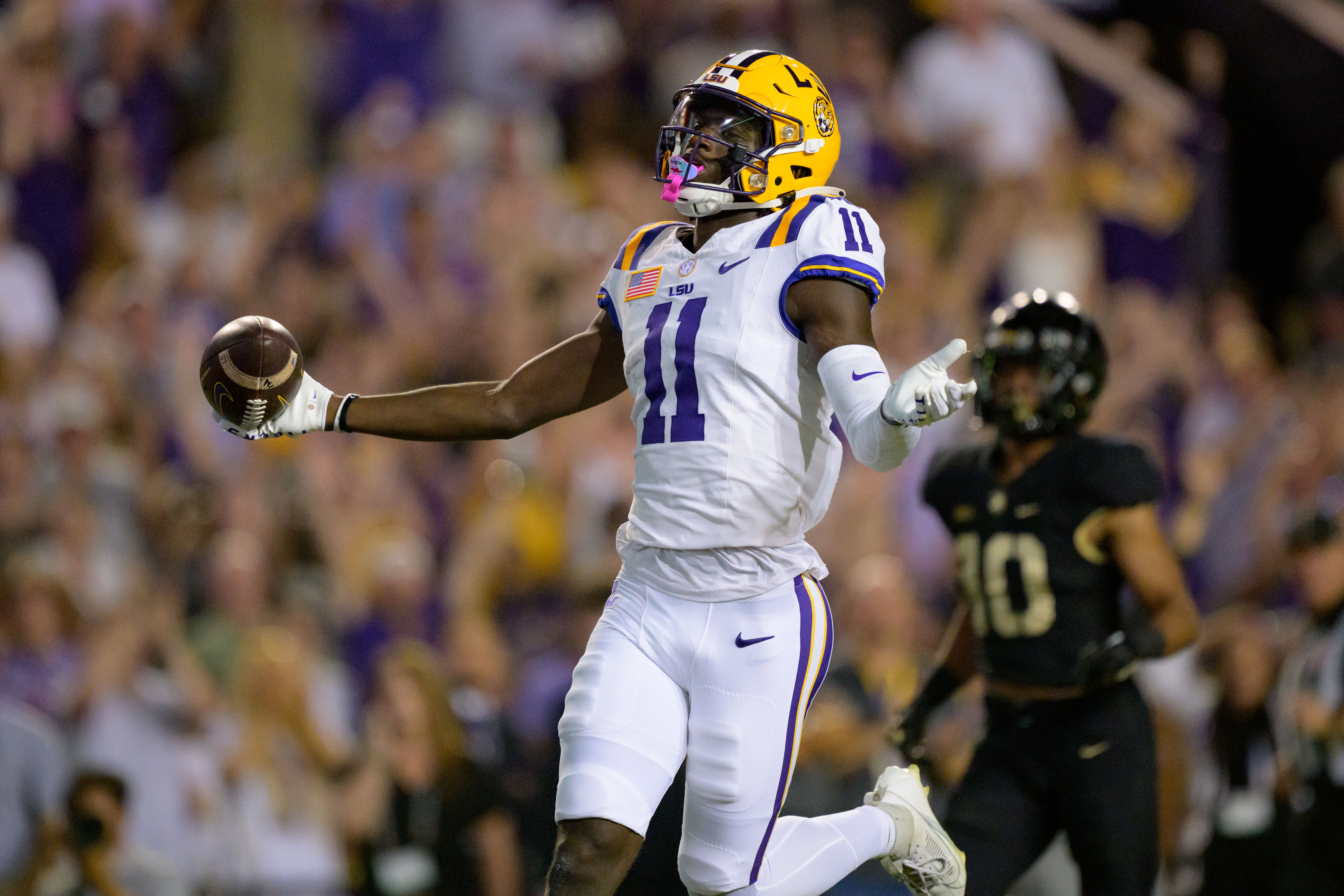 Oct 21, 2023; Baton Rouge, Louisiana, USA; LSU Tigers wide receiver Brian Thomas Jr. (11) (New York Giants draft prospect) celebrates after scoring a touchdown against Army Black Knights defensive back Cameron Jones (10) during the first quarter at Tiger Stadium. Mandatory Credit: Matthew Hinton-USA TODAY Sports