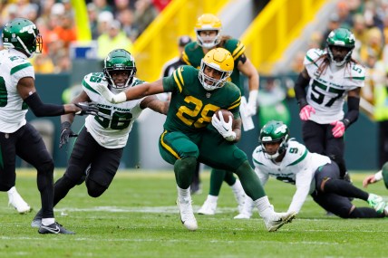 Green Bay Packers running back AJ Dillon (28) rushes with the football during the third quarter against the New York Jets at Lambeau Field