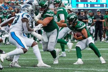 New York Jets running back Travis Dye (35) follows the block by center Joe Tippmann (66) during the second half against the Carolina Panthers at Bank of America Stadium