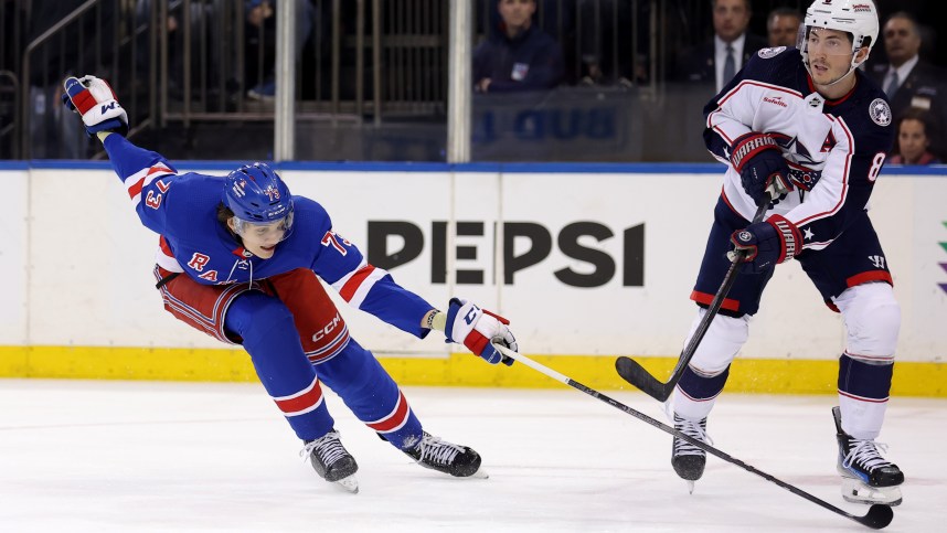 Columbus Blue Jackets defenseman Zach Werenski (8) plays the puck against New York Rangers center Matt Rempe (73) during the second period at Madison Square Garden