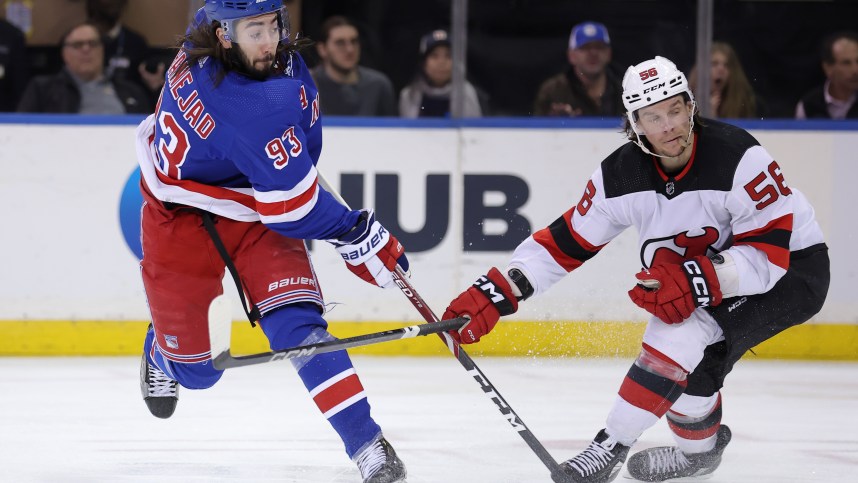 New York Rangers center Mika Zibanejad (93) follows through on a shot against New Jersey Devils left wing Erik Haula (56) during the third period at Madison Square Garden