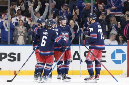 New York Rangers left wing Alexis Lafreniere (13) celebrates his goal with teammates during the third period against the New York Islanders at Madison Square Garden