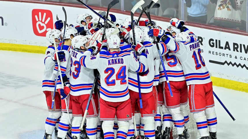 The New York Rangers celebrate after beating the Arizona Coyotes at Mullett Arena