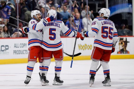 New York Rangers center Vincent Trocheck (16) celebrates with defenseman Chad Ruhwedel (5) and defenseman Ryan Lindgren (55) after the game against the Colorado Avalanche at Ball Arena