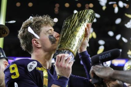 Michigan quarterback J.J. McCarthy kisses the championship trophy to celebrate the Wolverines' 34-13 win over Washington in the national championship game at NRG Stadium in Houston (New York Giants prospect)