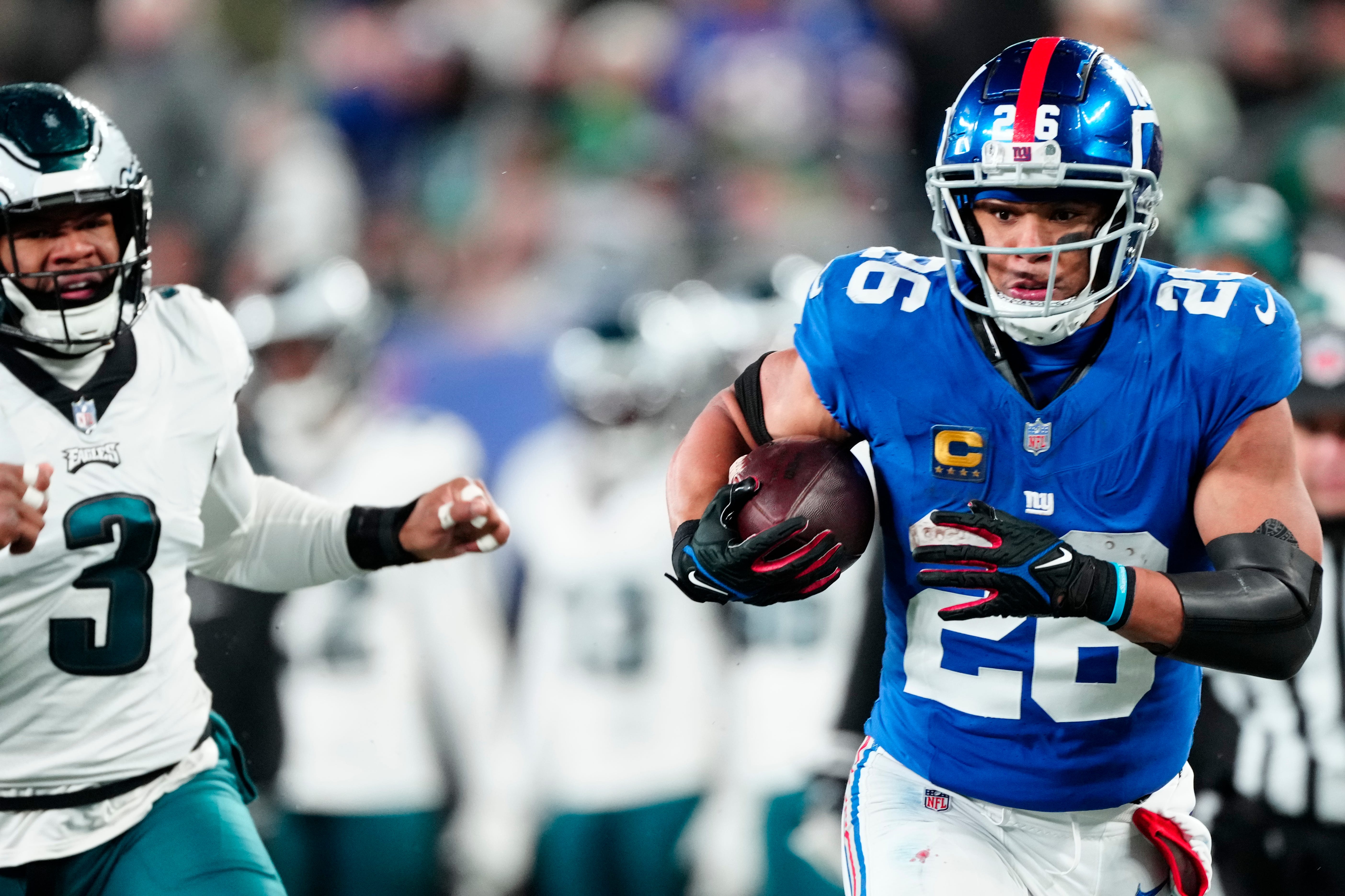 New York Giants running back Saquon Barkley (26) heads to the goal line in the second quarter past Philadelphia Eagles linebacker Nolan Smith