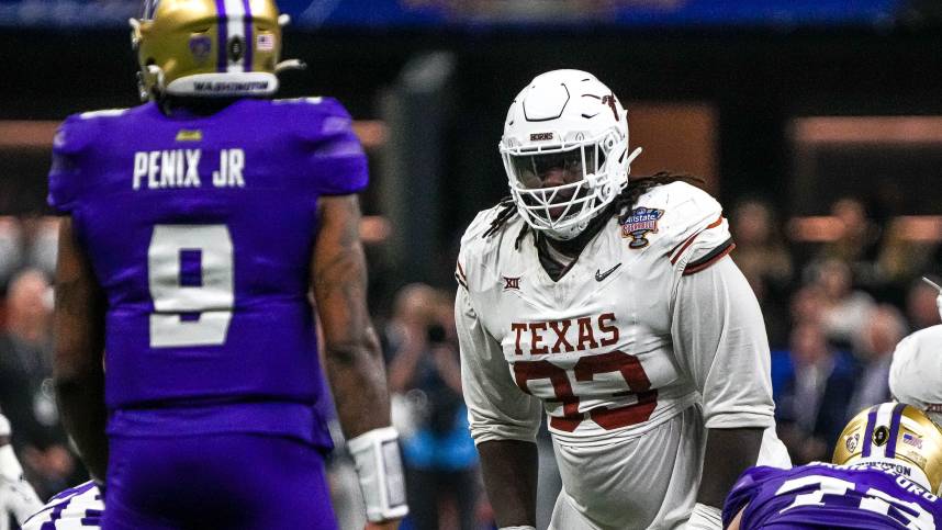 Texas Longhorns defensive lineman T'Vondre Sweat (93) watches Washington quarterback Michael Penix Jr. (9) before a snap during the Sugar Bowl College Football Playoff  semifinals game at the Caesars Superdome (New York Giants)