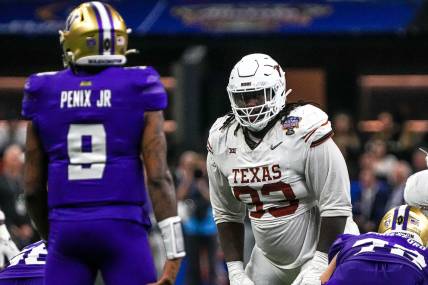 Texas Longhorns defensive lineman T'Vondre Sweat (93) watches Washington quarterback Michael Penix Jr. (9) before a snap during the Sugar Bowl College Football Playoff  semifinals game at the Caesars Superdome (New York Giants)
