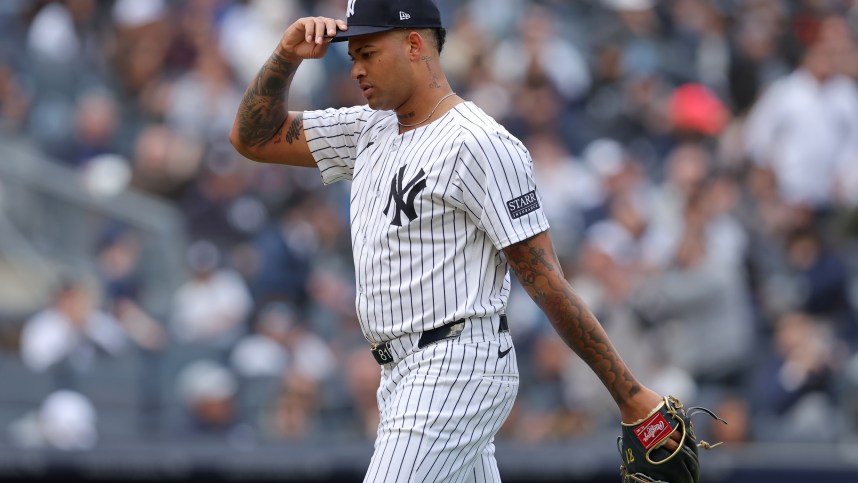 New York Yankees starting pitcher Luis Gil (81) adjusts his cap as he walks off the field after being taken out of the game during the sixth inning against the Tampa Bay Rays at Yankee Stadium