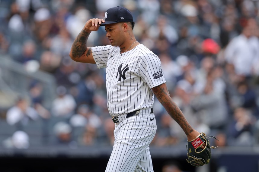 New York Yankees starting pitcher Luis Gil (81) adjusts his cap as he walks off the field after being taken out of the game during the sixth inning against the Tampa Bay Rays at Yankee Stadium