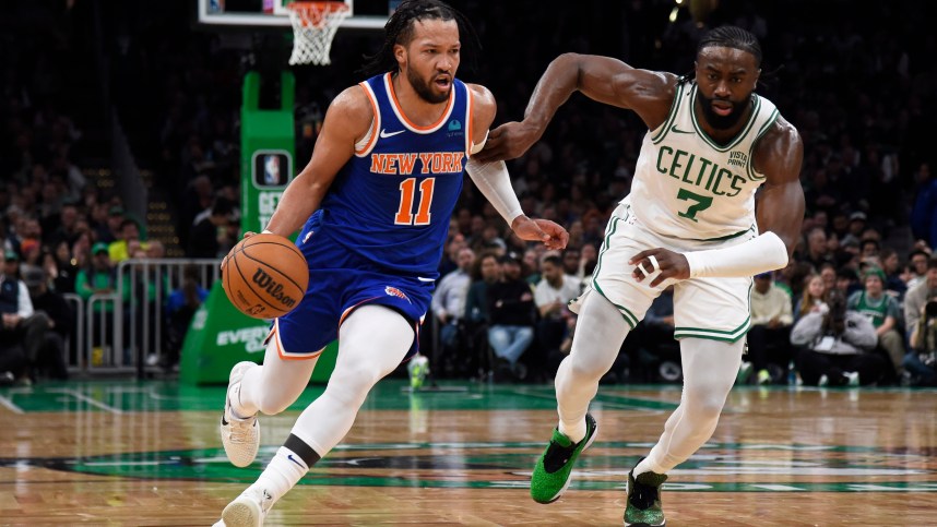 New York Knicks guard Jalen Brunson (11) controls the ball while Boston Celtics guard Jaylen Brown (7) defends during the first half at TD Garden.