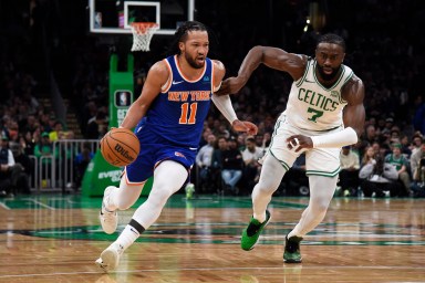 New York Knicks guard Jalen Brunson (11) controls the ball while Boston Celtics guard Jaylen Brown (7) defends during the first half at TD Garden.