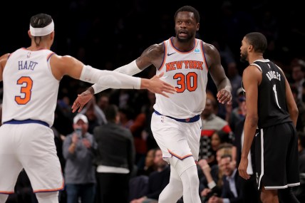 New York Knicks forward Julius Randle (30) high fives guard Josh Hart (3) in front of Brooklyn Nets forward Mikal Bridges (1) during the fourth quarter at Barclays Center