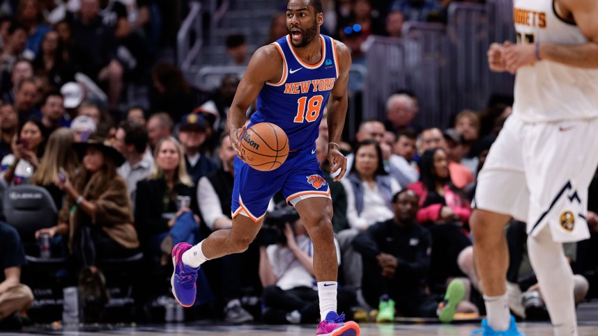 New York Knicks guard Alec Burks (18) dribbles the ball up court in the fourth quarter against the Denver Nuggets at Ball Arena