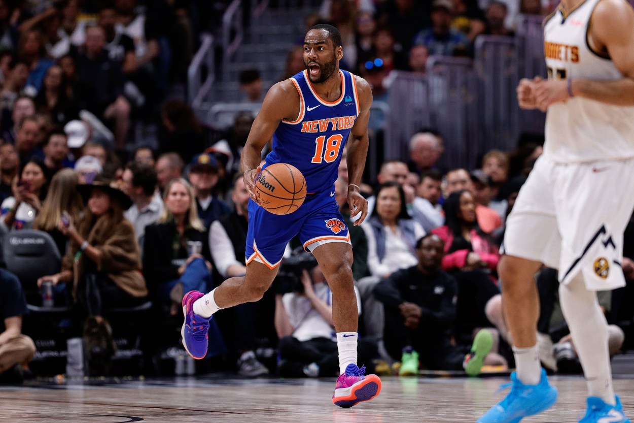 New York Knicks guard Alec Burks (18) dribbles the ball up court in the fourth quarter against the Denver Nuggets at Ball Arena