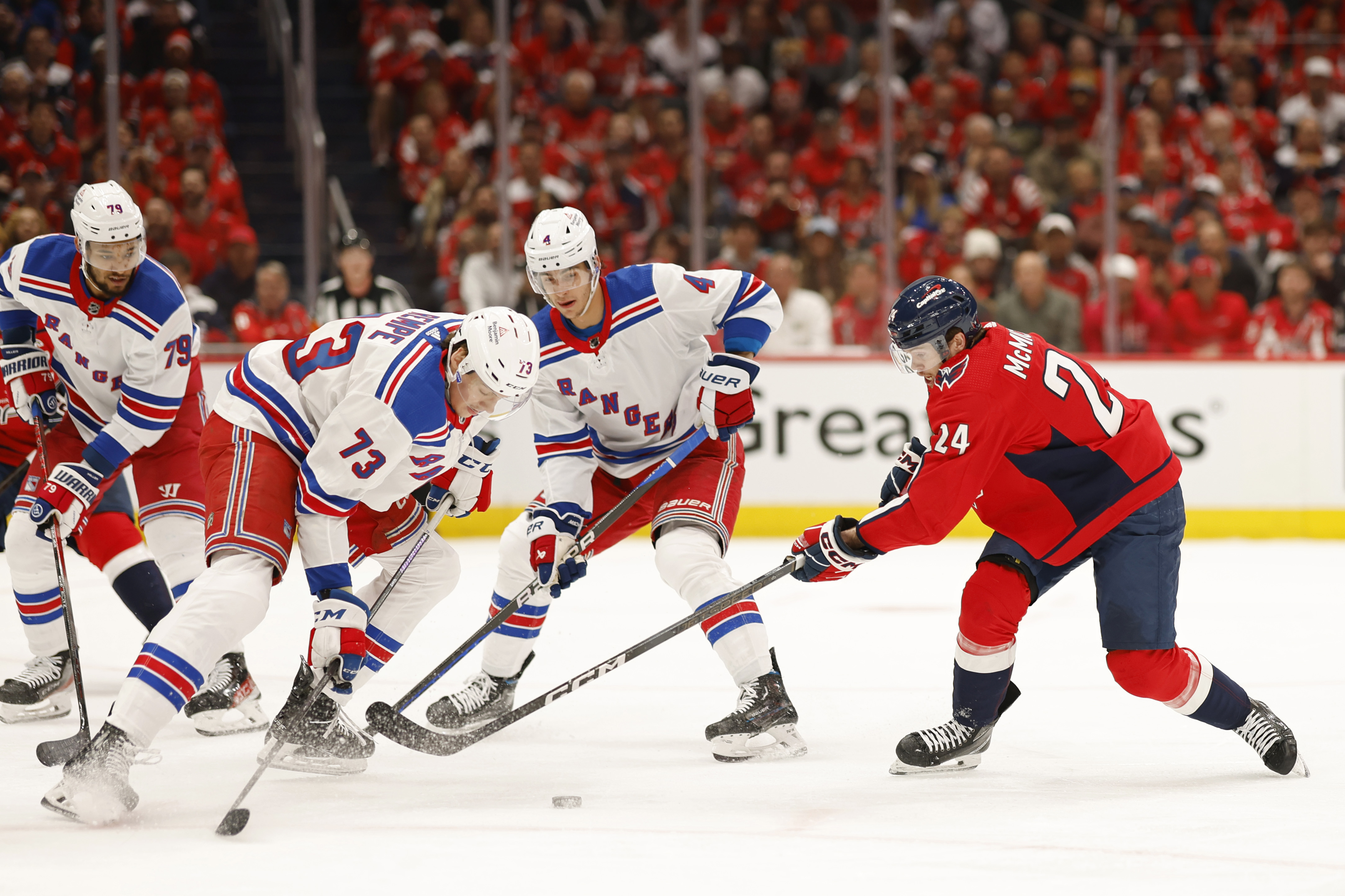 Apr 26, 2024; Washington, District of Columbia, USA; New York Rangers center Matt Rempe (73) and Washington Capitals center Connor McMichael (24) battle for the puck in the first period in game three of the first round of the 2024 Stanley Cup Playoffs at Capital One Arena. Mandatory Credit: Geoff Burke-USA TODAY Sports