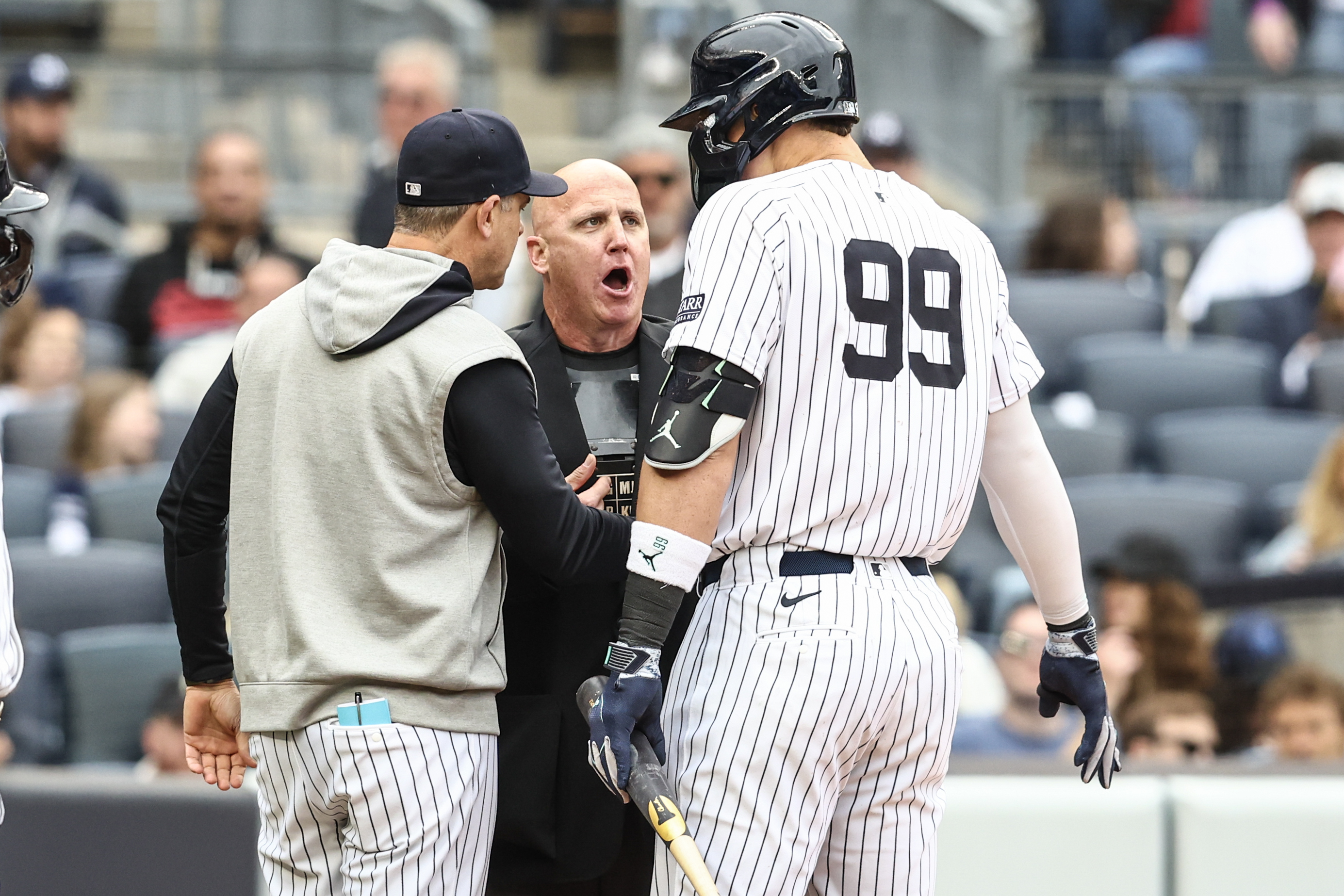 May 4, 2024; Bronx, New York, USA;  New York Yankees center fielder Aaron Judge (99) and manager Aaron Boone (17) argue with home plate umpire Ryan Blakney (36) in the seventh inning against the Detroit Tigers at Yankee Stadium. Mandatory Credit: Wendell Cruz-USA TODAY Sports