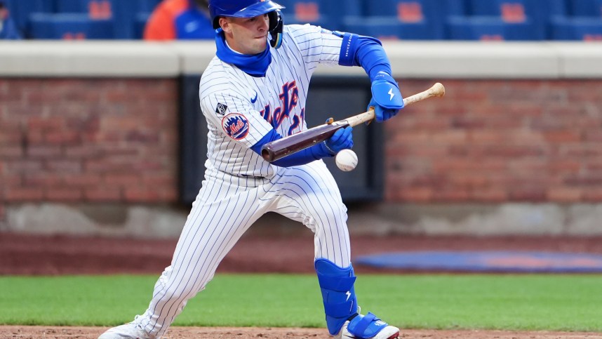 Apr 4, 2024; New York City, New York, USA; New York Mets third baseman Zack Short (21) lays down a sacrifice bunt against the Detroit Tigers during the eighth inning at Citi Field. Mandatory Credit: Gregory Fisher-USA TODAY Sports