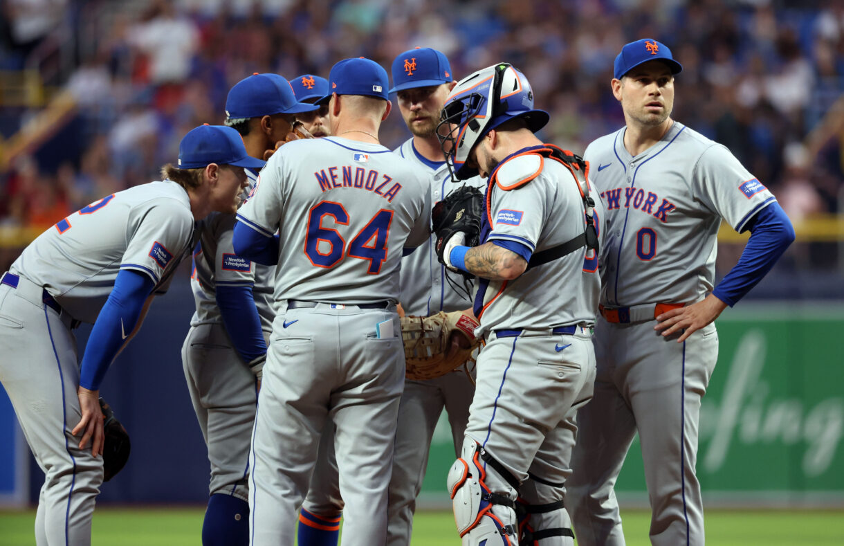 May 4, 2024; St. Petersburg, Florida, USA;  New York Mets manager Carlos Mendoza (64) comes out to the mound to talk with pitcher Adam Ottavino (0), catcher Tomas Nido (3), first base Pete Alonso (20), shortstop Francisco Lindor (12) and third base Brett Baty (22) against the Tampa Bay Rays during the eighth inning  at Tropicana Field. Mandatory Credit: Kim Klement Neitzel-USA TODAY Sports