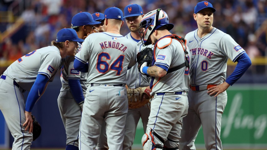 May 4, 2024; St. Petersburg, Florida, USA;  New York Mets manager Carlos Mendoza (64) comes out to the mound to talk with pitcher Adam Ottavino (0), catcher Tomas Nido (3), first base Pete Alonso (20), shortstop Francisco Lindor (12) and third base Brett Baty (22) against the Tampa Bay Rays during the eighth inning  at Tropicana Field. Mandatory Credit: Kim Klement Neitzel-USA TODAY Sports